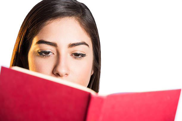 istock Young latin woman reading a book 621707810