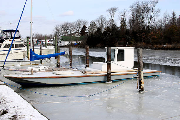 istock Clam boat docked and frozen in a canal 621708390