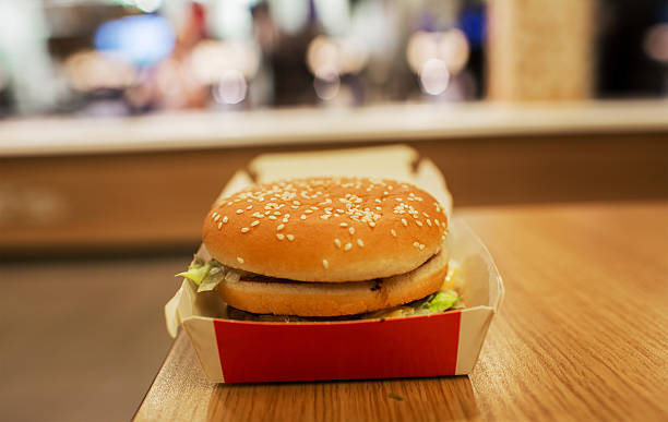istock cheeseburger on the table. fast food restaurants. 621708950