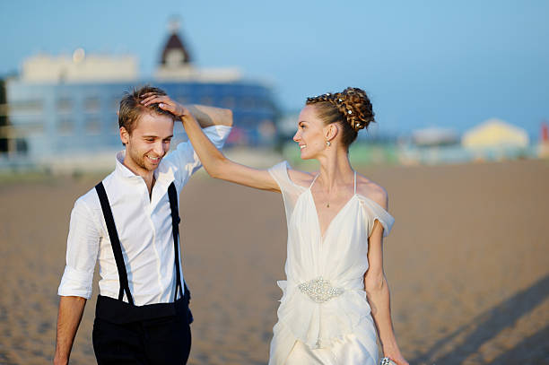 istock Beach wedding: bride and groom by the sea 621711268