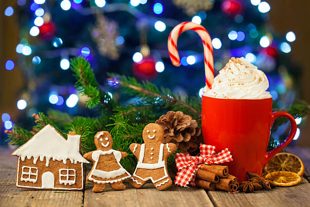 istock Christmas cappuccino and gingerbread cookies infront Christmas tree 621713020
