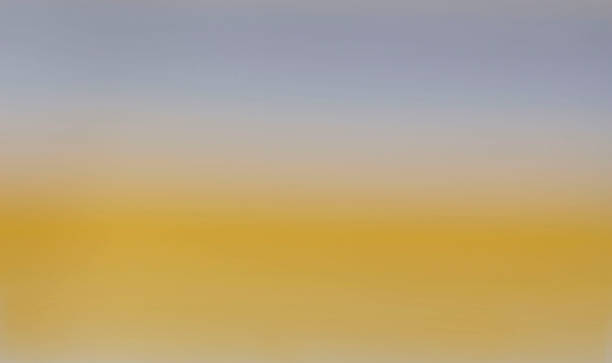 istock blank background image of yellow graduating to light blue. 621713128