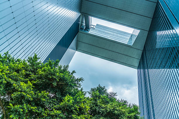 istock modern glass building and green leaves 621713270