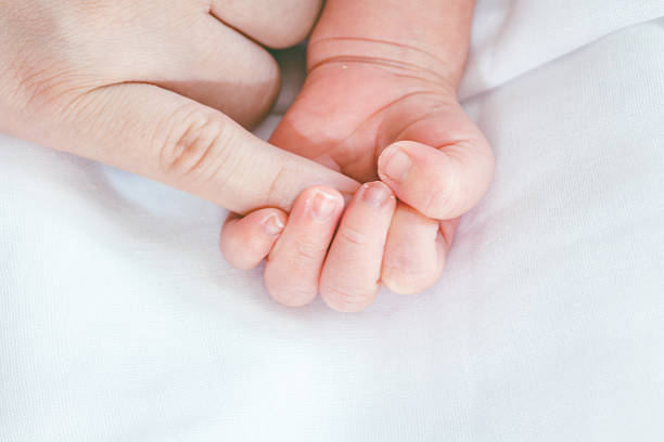 istock Baby hand with hand mother 621713438