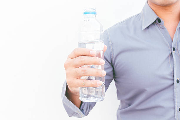 istock Man with water from bottle on white background 621713458