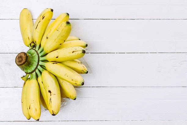istock Banana bunch on wooden background 621716162