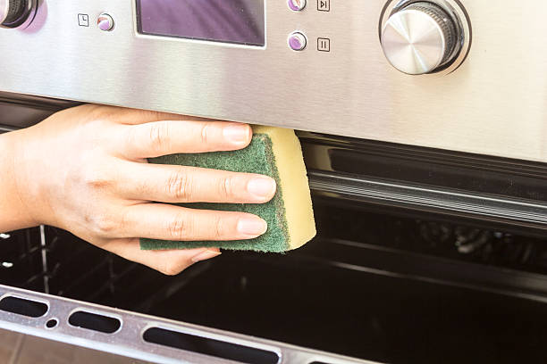 istock Hand cleaning oven at home kitchen 621716226