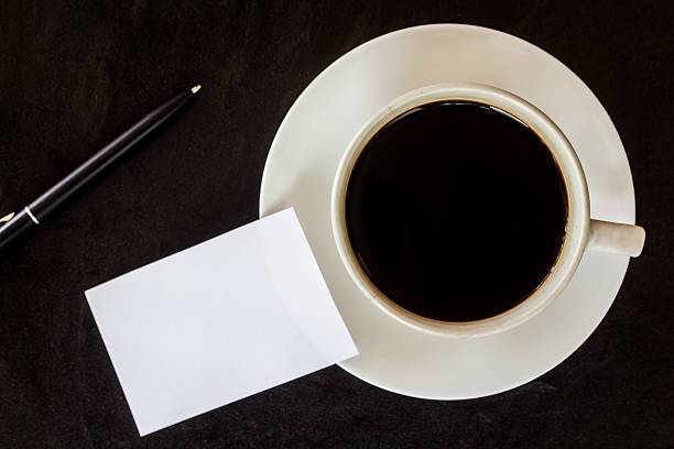 istock Business card and coffee cup on black background 621717312