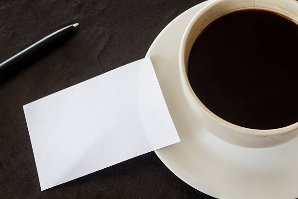 istock Business card and coffee cup on black background 621717348