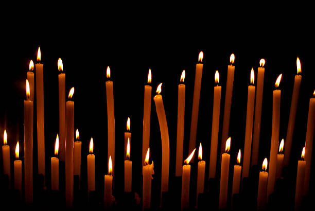 istock Church candles against dark background 621718188