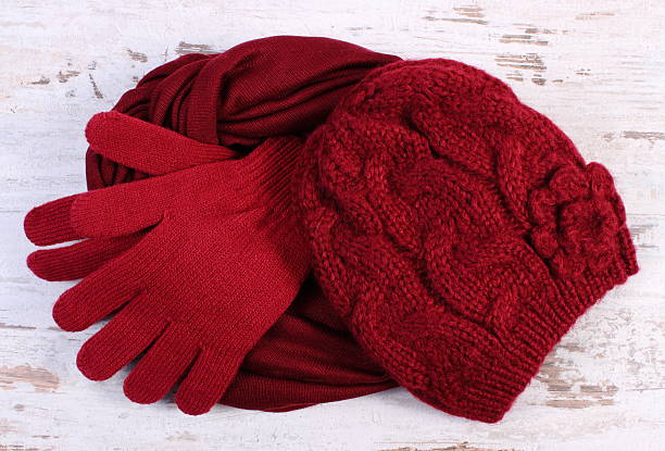 Pair of woolen gloves, cap and shawl for woman stock photo