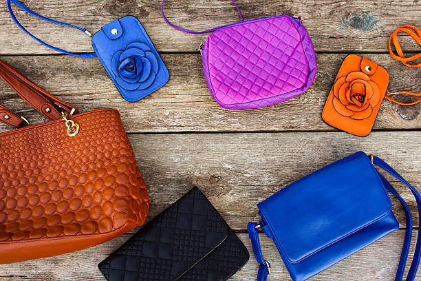 istock Colored handbags on wooden background. 621720804