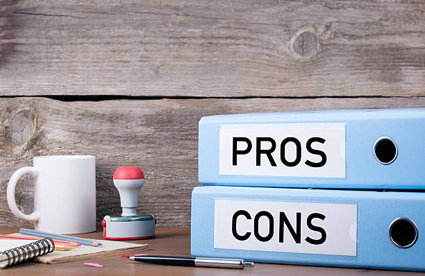 istock Pros and Cons. Two binders on desk in the office 621721580