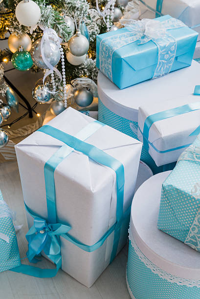 istock Christmas gift boxes with blue bow and bokeh lights on 621721842