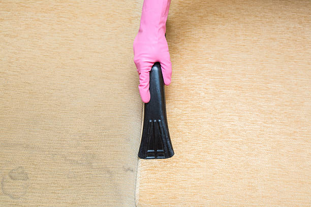 istock Professionally nozzle releasing sofa from dust. Clean and dirty side. 621722138
