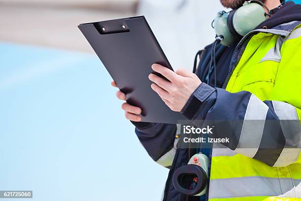 Ground Crew In Front Of Airplane Stock Photo - Download Image Now - Air Vehicle, Examining, Airport