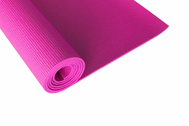 istock pink yoga mat isolated on white. 621725226
