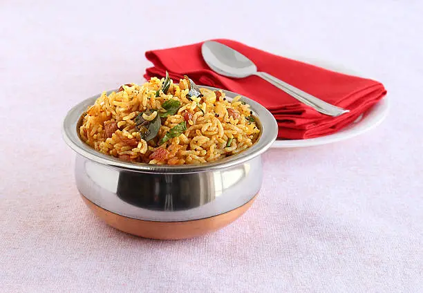 Indian food tamarind rice, which is a vegetarian, traditional, popular and south Indian rice dish, in a bowl.
