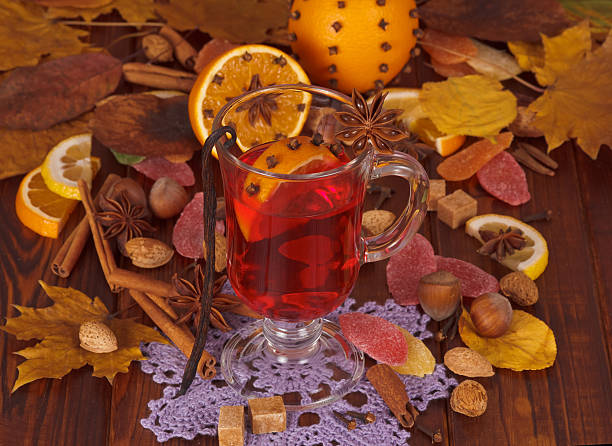 istock Mulled wine spices and fruit, nuts, candy on autumn leaves. 621725658