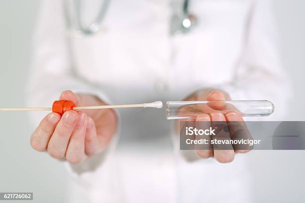 Female Forensic Technician Collecting Biological Specimen In Dna Stock Photo - Download Image Now