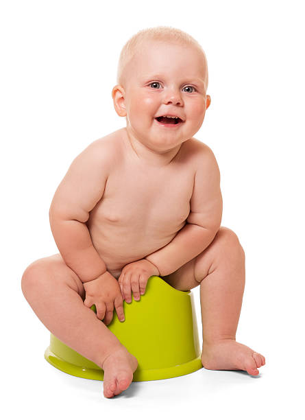 istock Happy little boy sits on chamber pot plastic isolated. 621726450