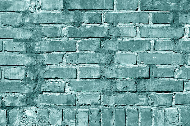 istock Grungy cyan toned brick wall texture. 621726880