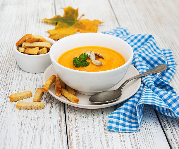 istock Pumpkin soup with fresh pumpkins 621727750