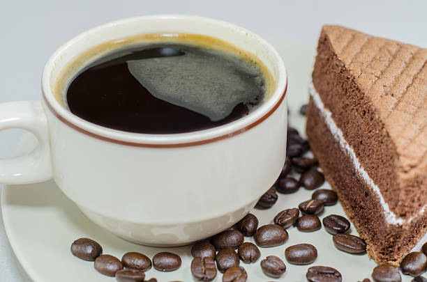 cup of coffee with slice chocolate cake on white background - latté hot chocolate hot drink indulgence imagens e fotografias de stock