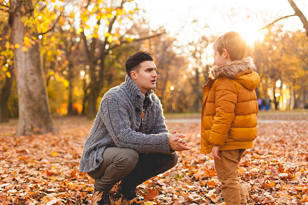 istock Father and son talking at the park 621730130