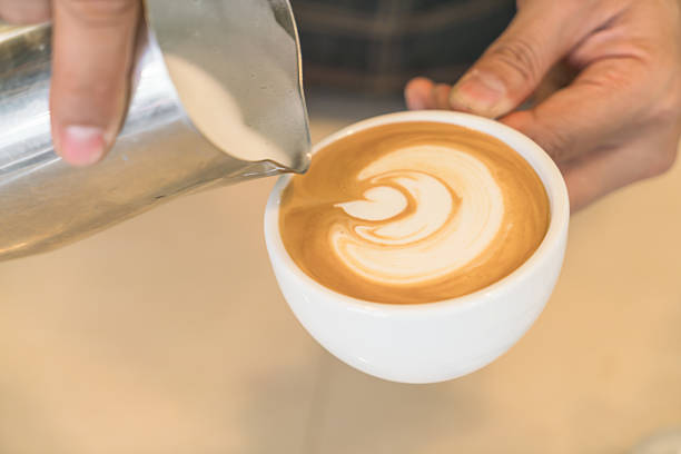 istock Pouring milk to make latte coffee art 621730322