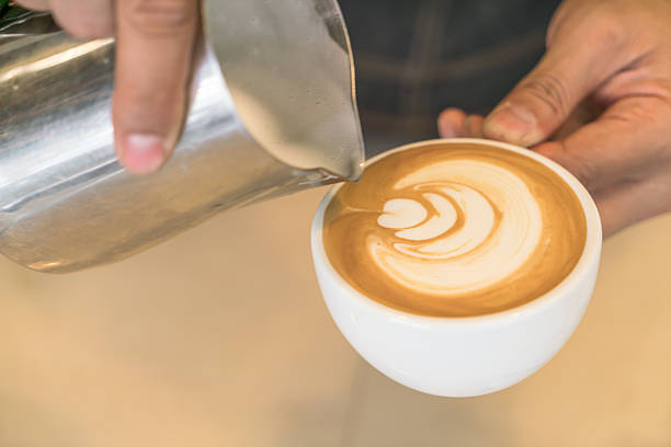 istock Pouring milk to make latte coffee art 621730404
