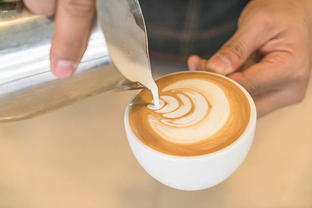 istock Pouring milk to make latte coffee art 621730456