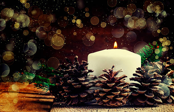 Burning candles near the mirror. Beautiful handmade candles. Cozy atmosphere in the house