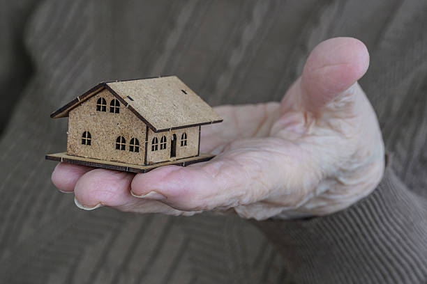 istock Holding a small house on palm 621732556