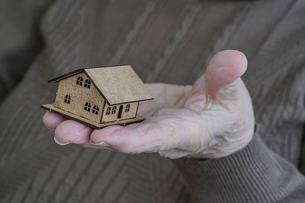 istock Holding a small house on palm 621732598