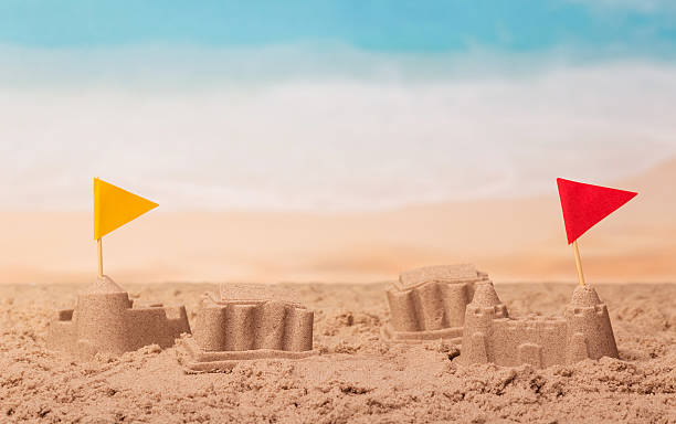 istock Sandcastles with flags on the background of sea. 621814990