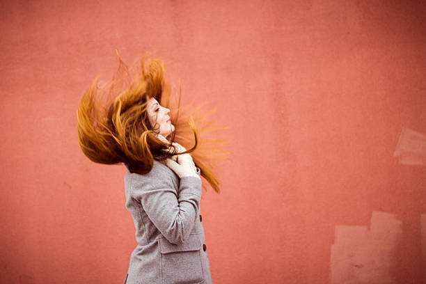 istock girl with beautiful long hair developing on wind 621815168