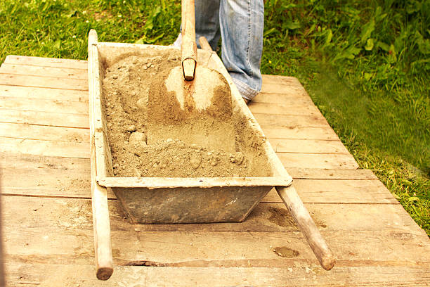 istock man prevents the concrete by hand shovel 621816022