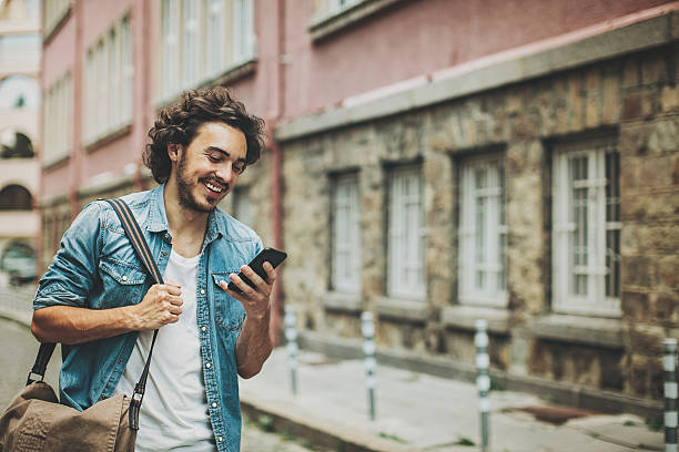 istock Man with smart phone on the street 621816528