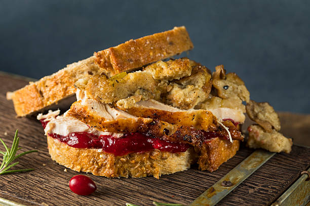 Homemade Thanksgiving Leftover Turkey Sandwich Homemade Thanksgiving Leftover Turkey Sandwich with Stuffing and Cranberry leftovers photos stock pictures, royalty-free photos & images