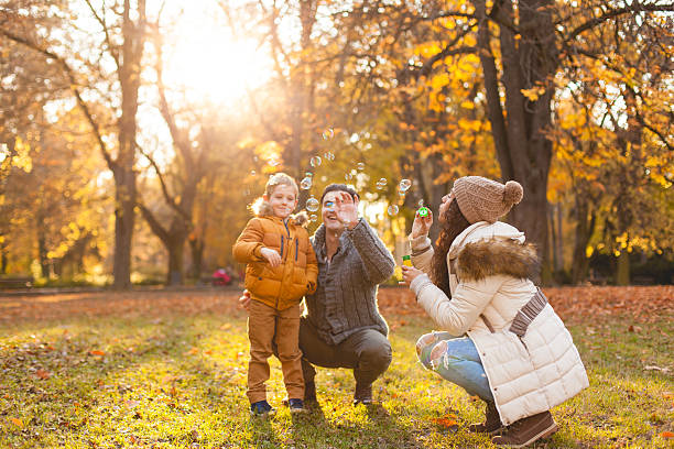 istock Happy family blowing bubbles 621817004