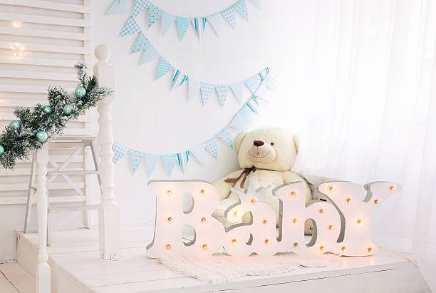 White bedroom for child with blue and white decorations designed with teddy bear and Christmas decorations, for boys and girls