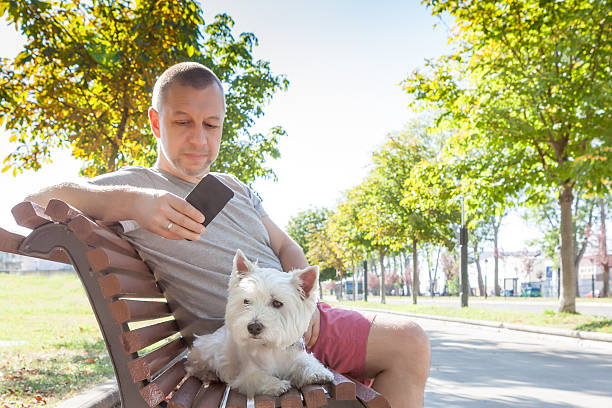 istock Man with dog on the bench 621817668