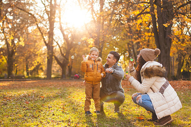 istock Happy family blowing bubbles 621817884