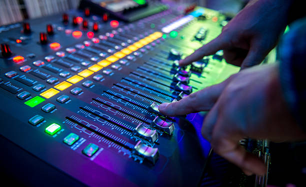 sound mixer DJ mixing music on sound board volume knob photos stock pictures, royalty-free photos & images