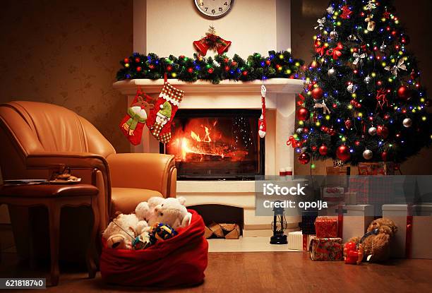 Christmas Tree And Christmas Gift Boxes In Interior With Fireplace Stock Photo - Download Image Now