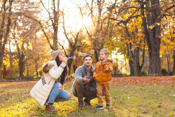 istock Happy family blowing bubbles 621818760