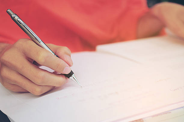 istock Monk's Hand writing in a book with the pencil 621819302