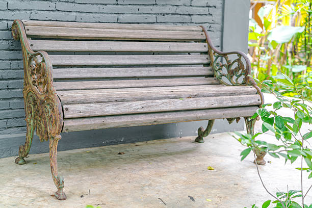istock Wood Bench against a brick wall 621819638