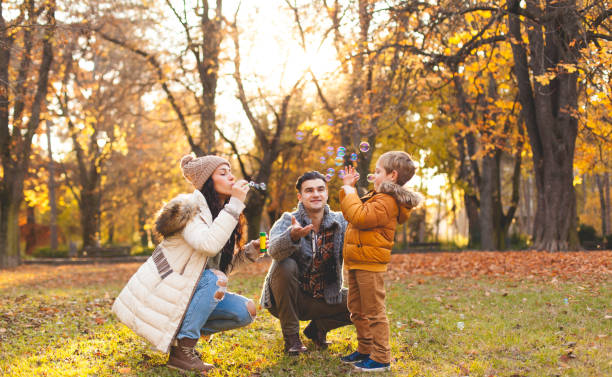 istock Happy family blowing bubbles 621819938